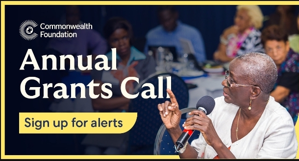 Commonwealth annual grants call. Woman at the corner right, holding a microphone and airing her views.